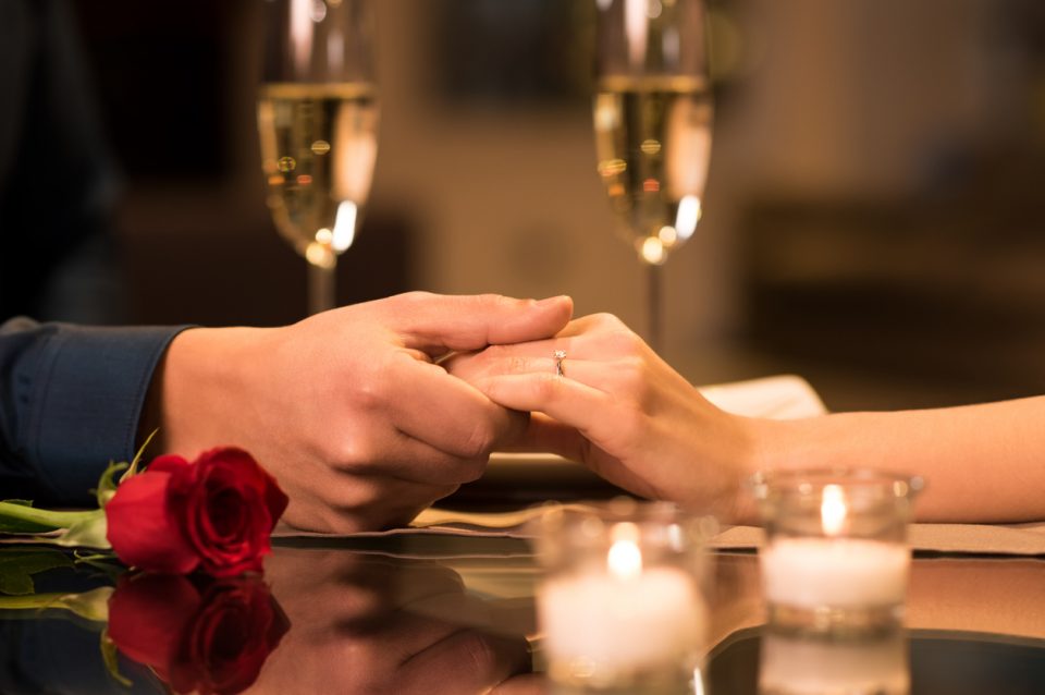 Couple holding hands at a romantic restaurant