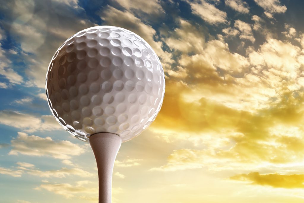 Golf ball on tee symbolizing Top Golf